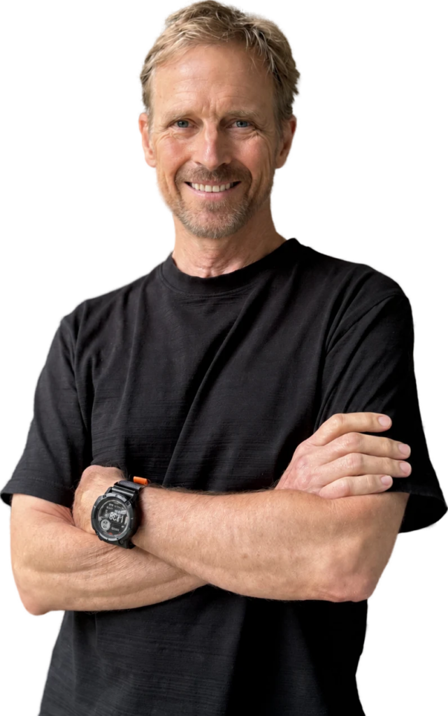 Joe Tennis, smiling, arms crossed, in a black T-shirt
