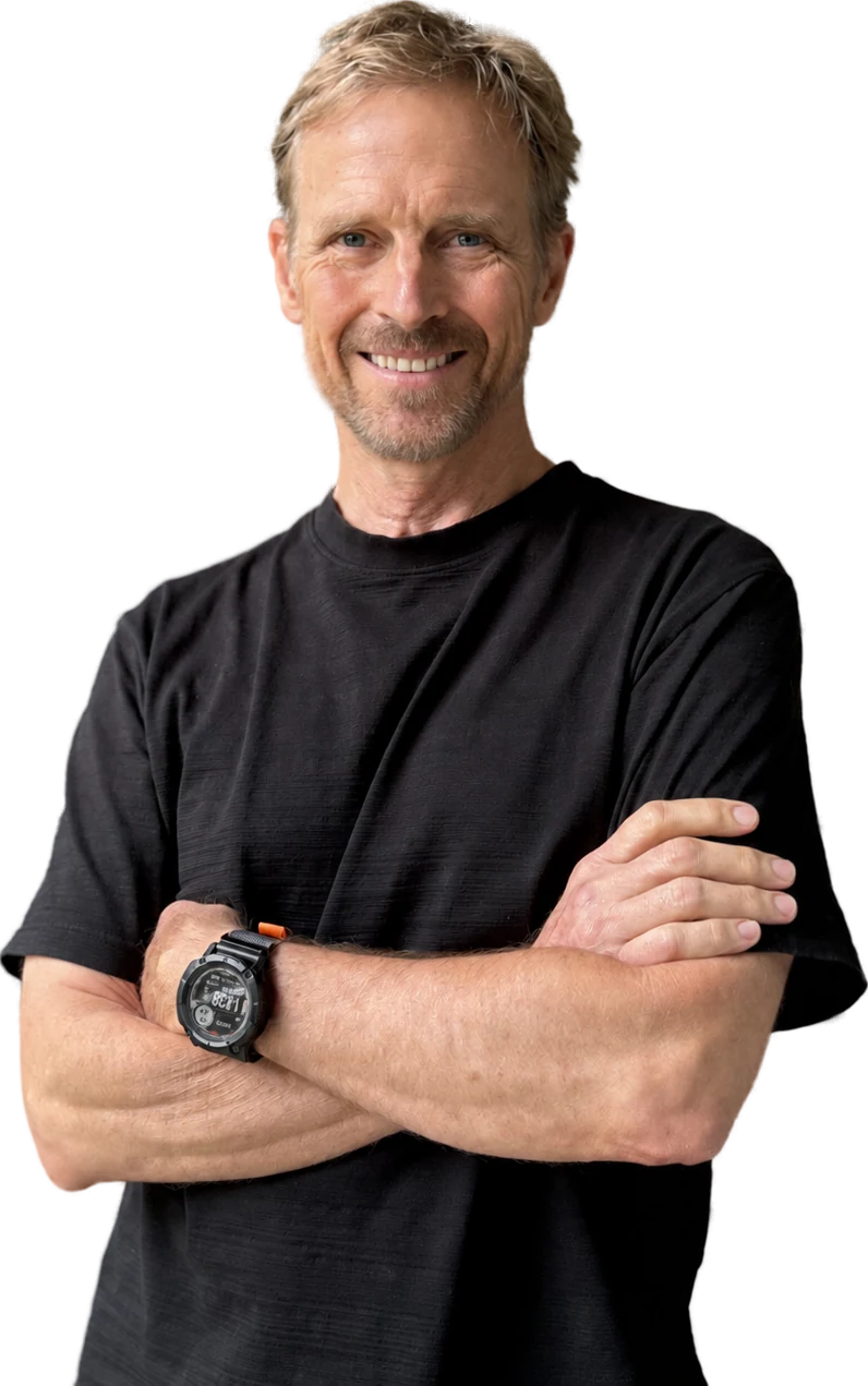 Joe Tennis, smiling, arms crossed, in a black T-shirt